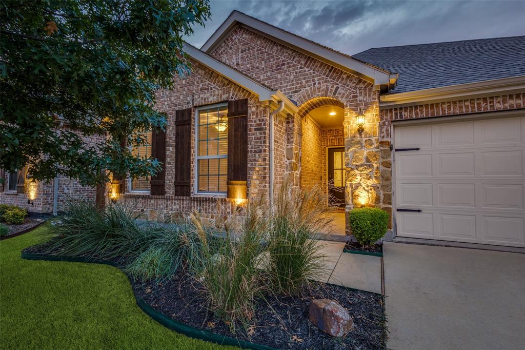 413 Yellowstone Drive Celina, TX 75009 - Photo 2 of 33 a front view of a house with garden