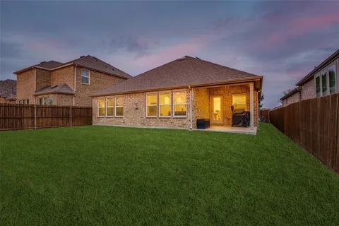 a front view of a house with a garden and yard