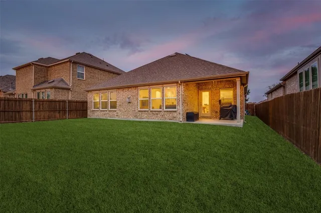 a front view of a house with a garden and yard