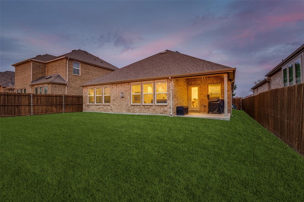 413 Yellowstone Drive Celina, TX 75009 - Photo 25 of 33 a front view of a house with a garden and yard