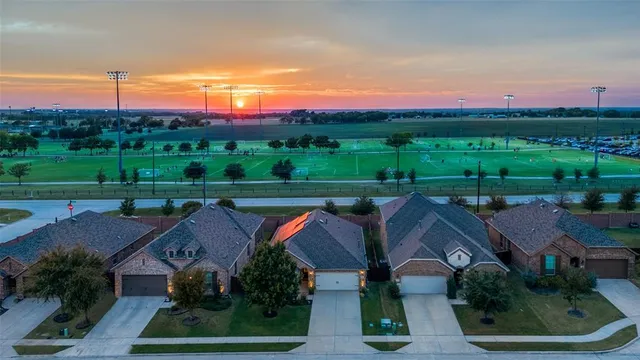 an aerial view of a house with garden space and street view