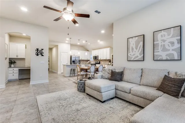a living room with furniture and kitchen view