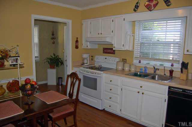 134 Wythe Circle Raleigh, NC 27615 - Photo 5 of 10 a kitchen with granite countertop white cabinets and white appliances