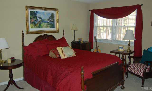 134 Wythe Circle Raleigh, NC 27615 - Photo 6 of 10 a bedroom with a bed and a painting on the wall