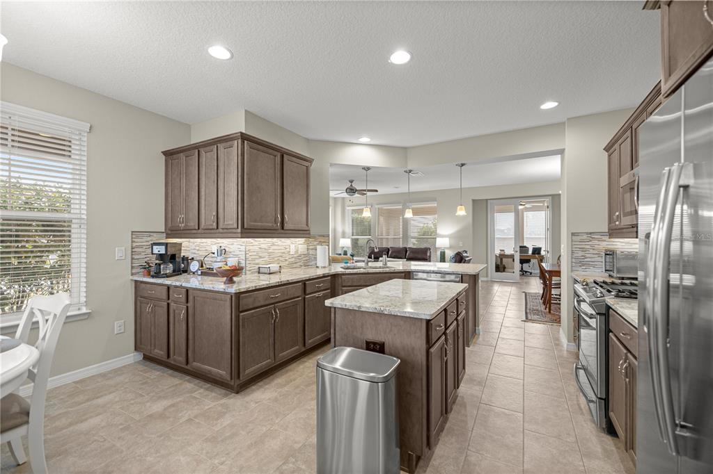 5504 Northwest 40th Loop Ocala, FL 34482 - Photo 11 of 31 a kitchen with stove top oven and refrigerator