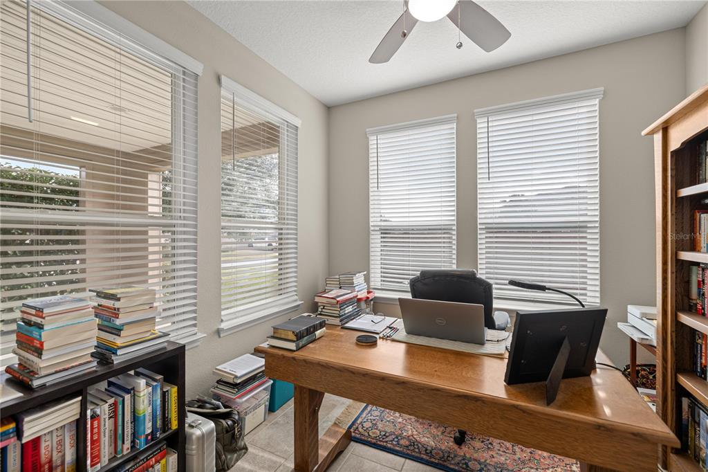 5504 Northwest 40th Loop Ocala, FL 34482 - Photo 14 of 31 a view of a workspace with furniture and a window