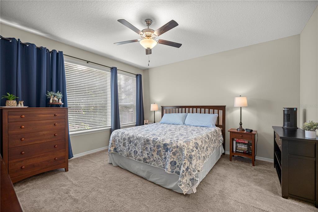 5504 Northwest 40th Loop Ocala, FL 34482 - Photo 15 of 31 a bedroom with a bed and a dresser