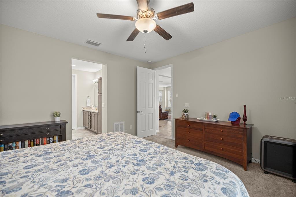 5504 Northwest 40th Loop Ocala, FL 34482 - Photo 16 of 31 a bedroom with a bed and a dresser