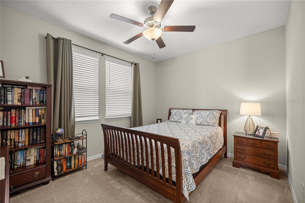5504 Northwest 40th Loop Ocala, FL 34482 - Photo 20 of 31 a bedroom with a bed and a book shelf