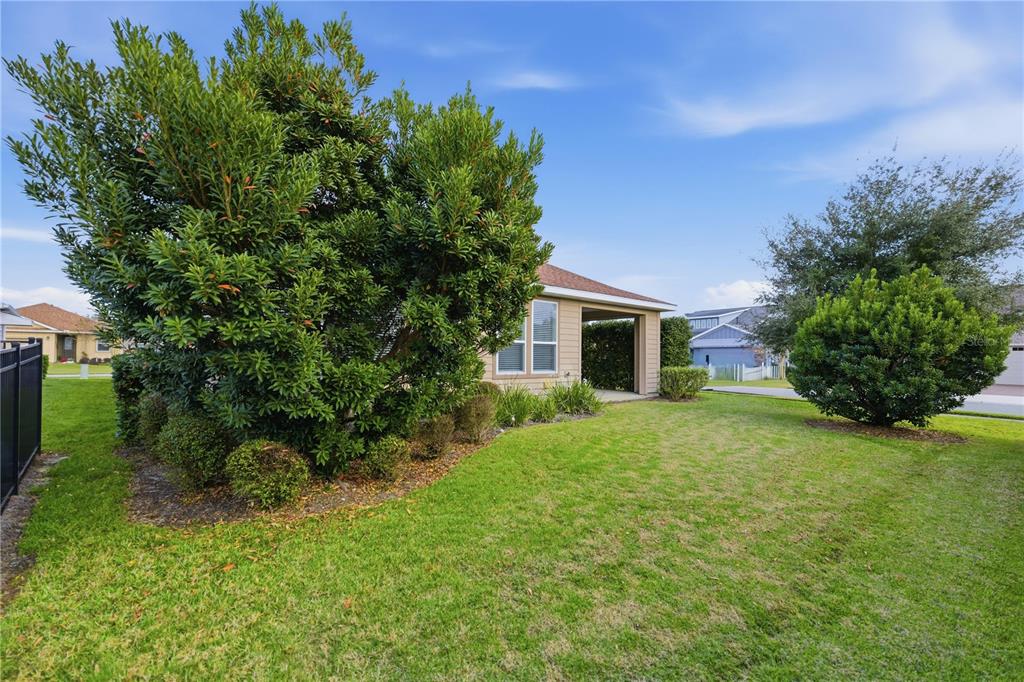 5504 Northwest 40th Loop Ocala, FL 34482 - Photo 28 of 31 a front view of a house with garden