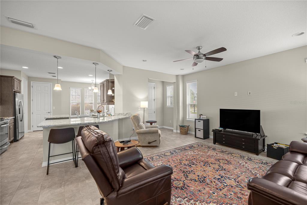 5504 Northwest 40th Loop Ocala, FL 34482 - Photo 5 of 31 a living room with furniture and a flat screen tv