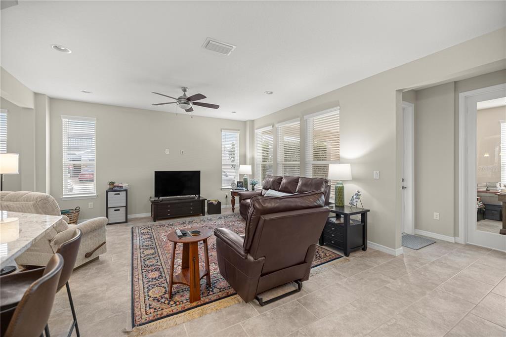 5504 Northwest 40th Loop Ocala, FL 34482 - Photo 6 of 31 a living room with furniture and a flat screen tv