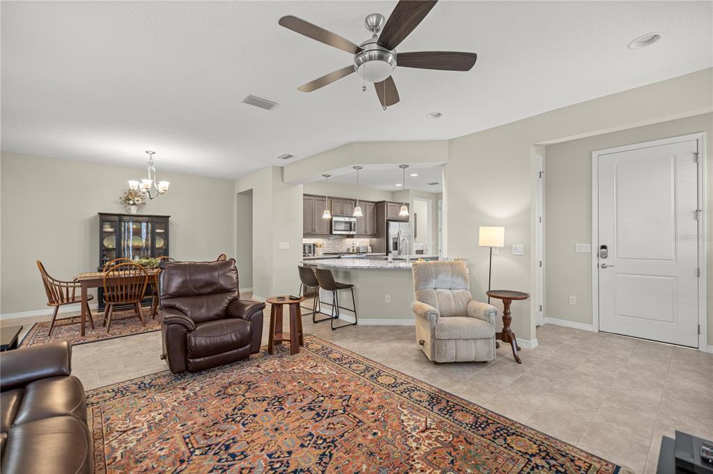 5504 Northwest 40th Loop Ocala, FL 34482 - Photo 7 of 31 a living room with furniture and a view of kitchen