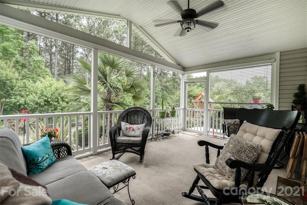 78166 Rillstone Drive Lancaster, SC 29720 - Photo 22 of 25 a living room with furniture and a floor to ceiling window