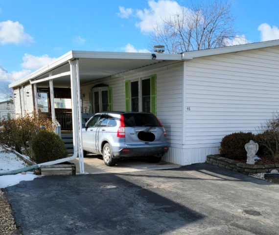 a car parked in front of a white house
