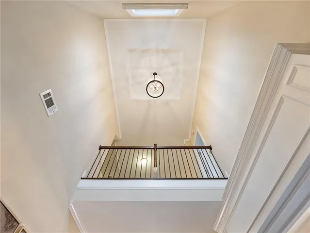a living room with furniture chandelier and a large window