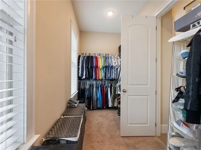 a front view of residential houses with yard and trees