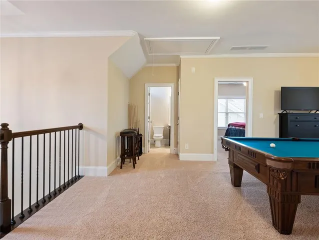 a view of a house with a yard and potted plants
