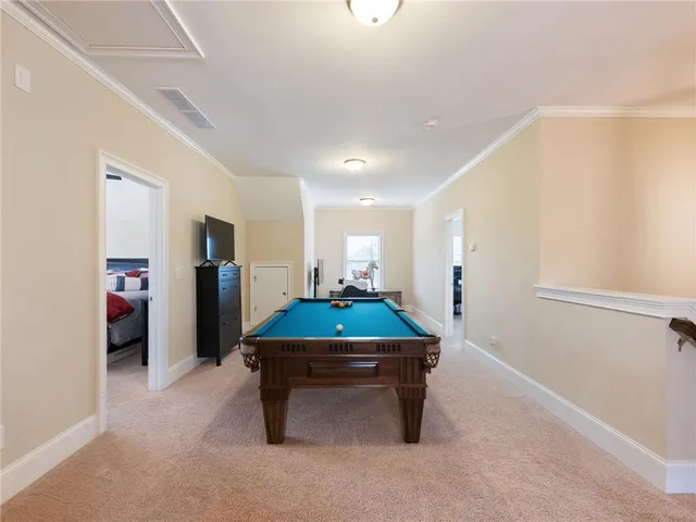 a view of a house with a wooden fence