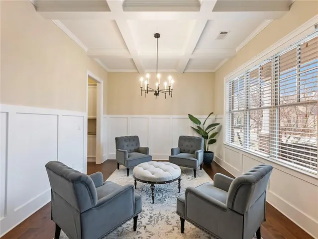 a living room with furniture a chandelier and a dining table