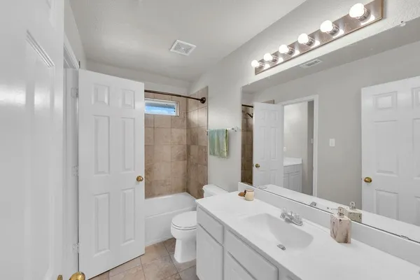 a bathroom with a sink double vanity granite and a mirror