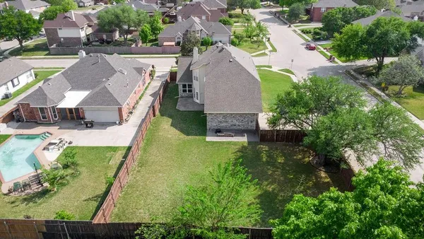 an aerial view of residential houses with outdoor space