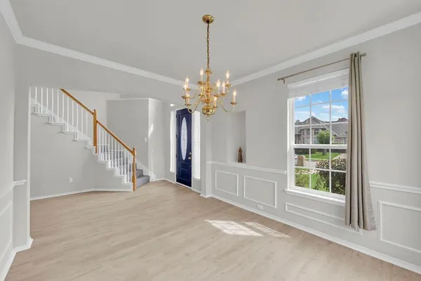 a view of a livingroom with a window and chandelier