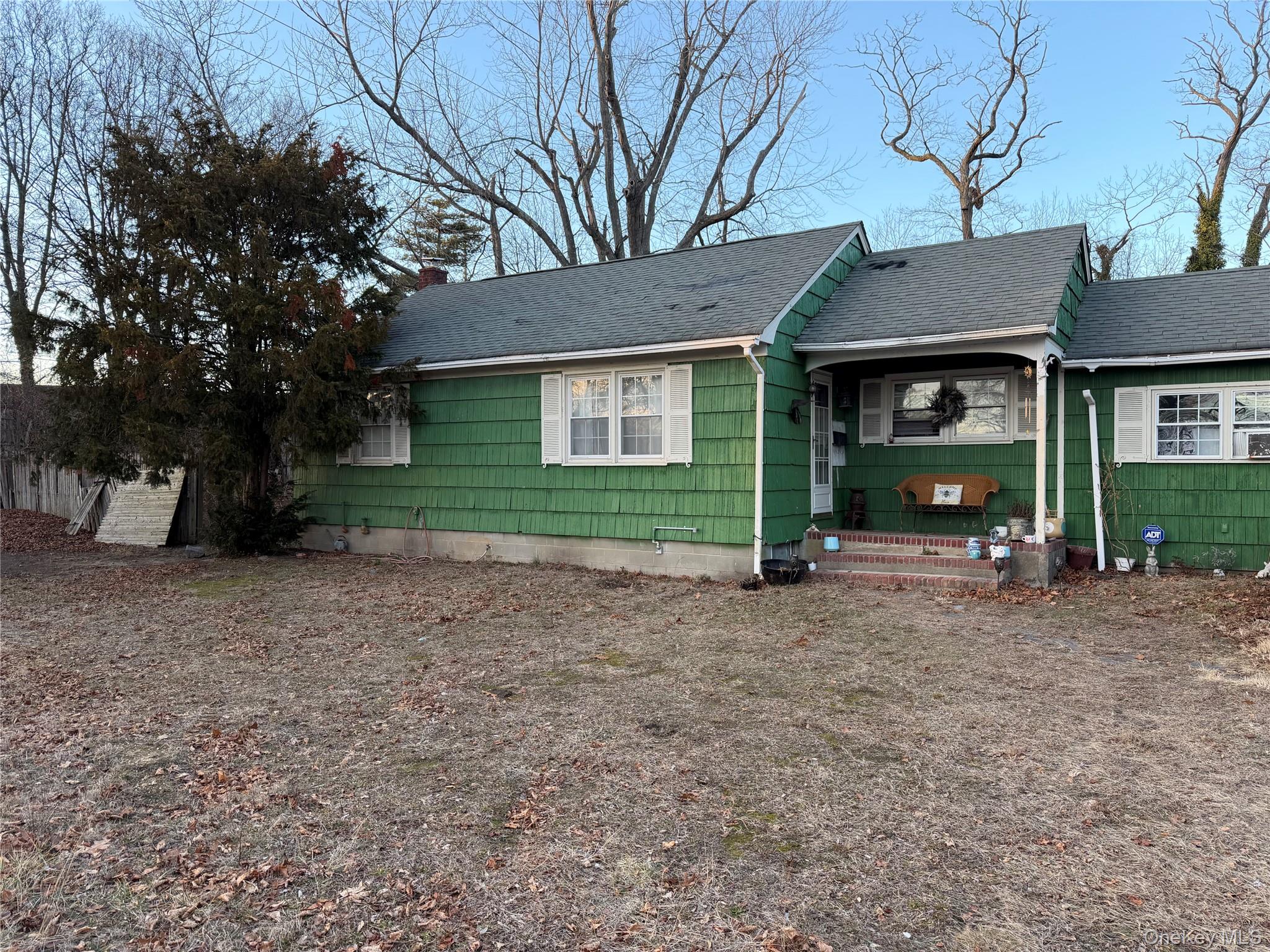 a view of a house with a yard and tree
