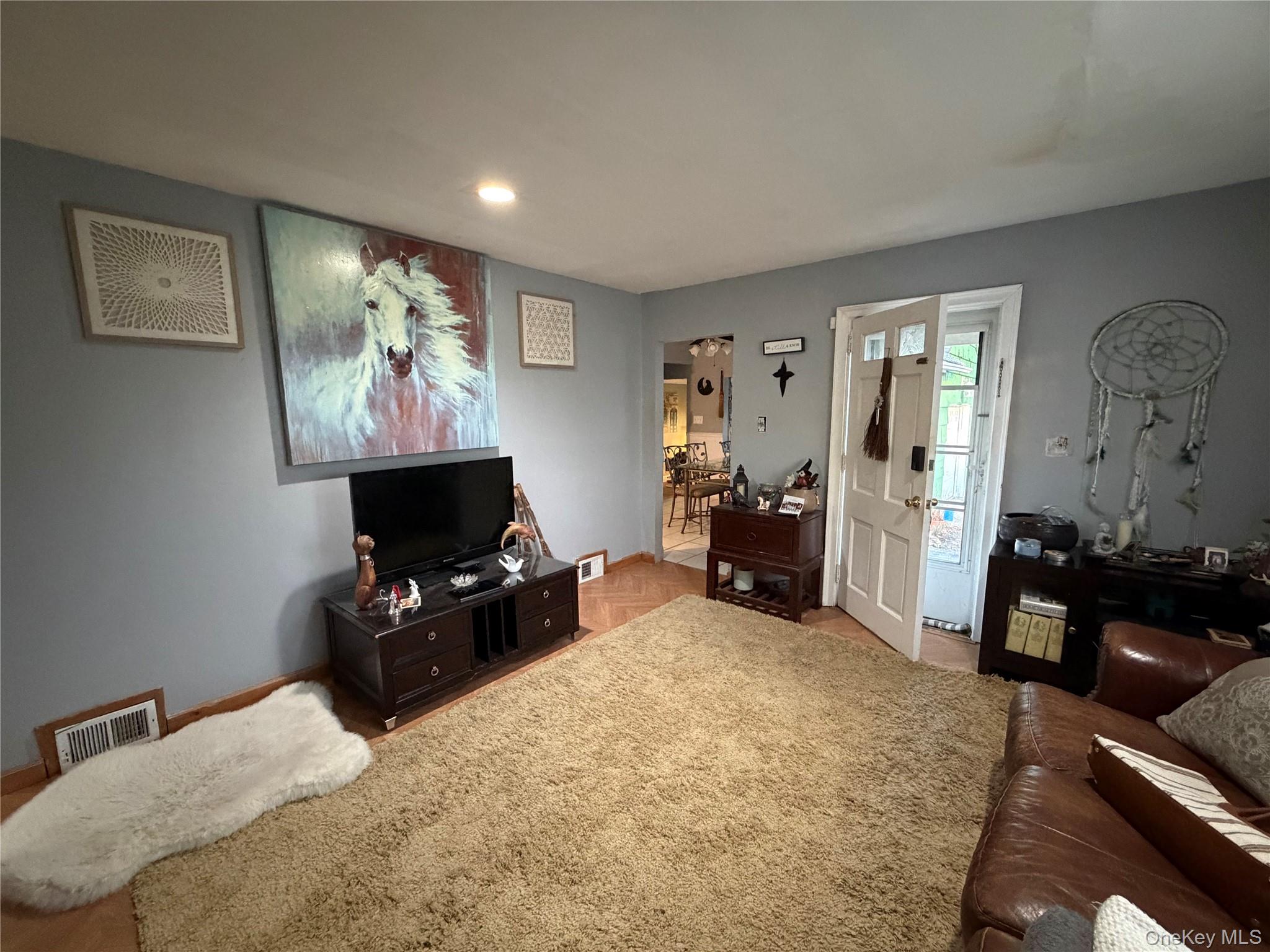 11 Bittermint Street Islip, NY 11751 - Photo 2 of 12 a bedroom with furniture and a flat screen tv