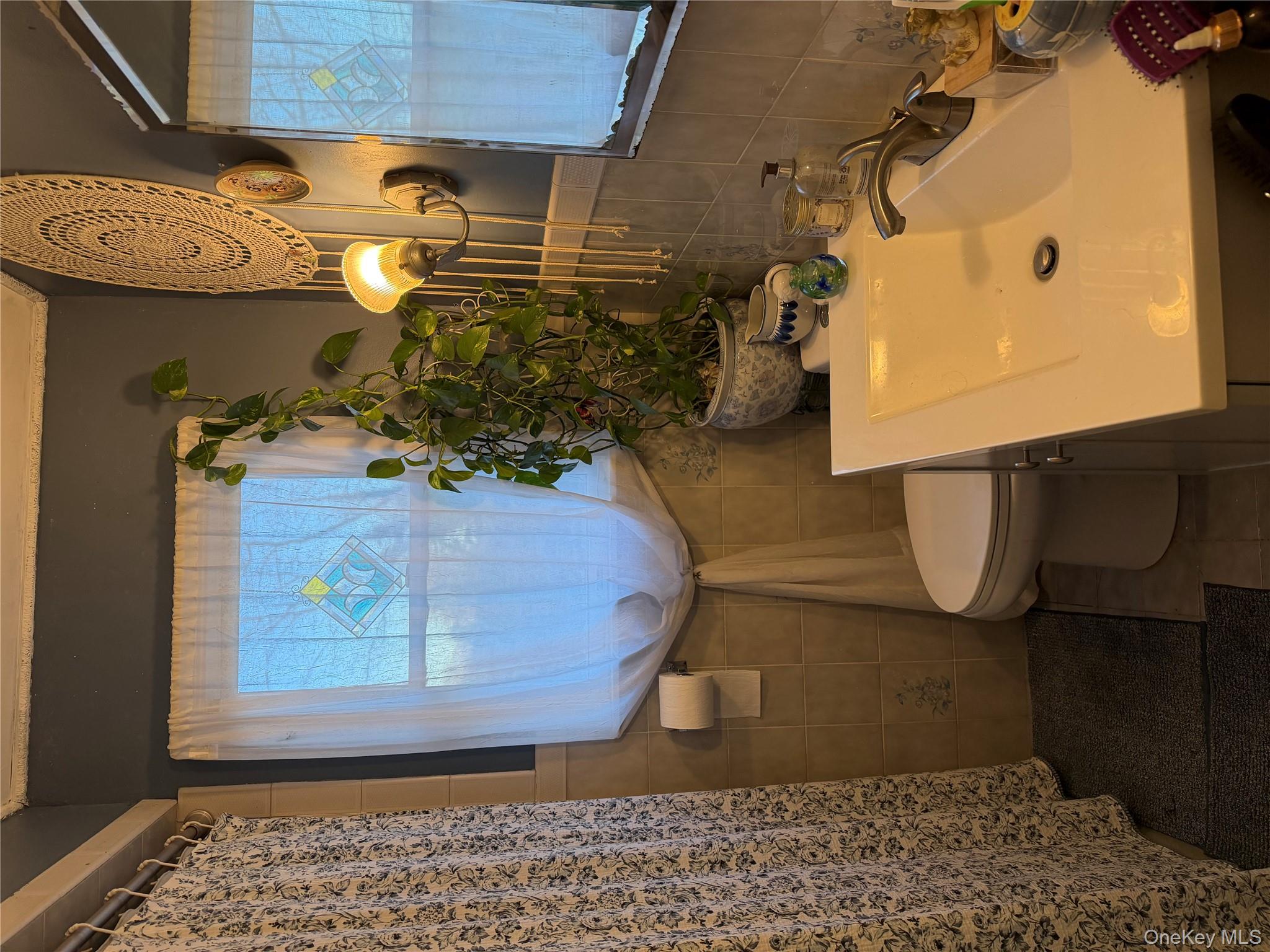 11 Bittermint Street Islip, NY 11751 - Photo 7 of 12 a bathroom with a sink a toilet and a mirror