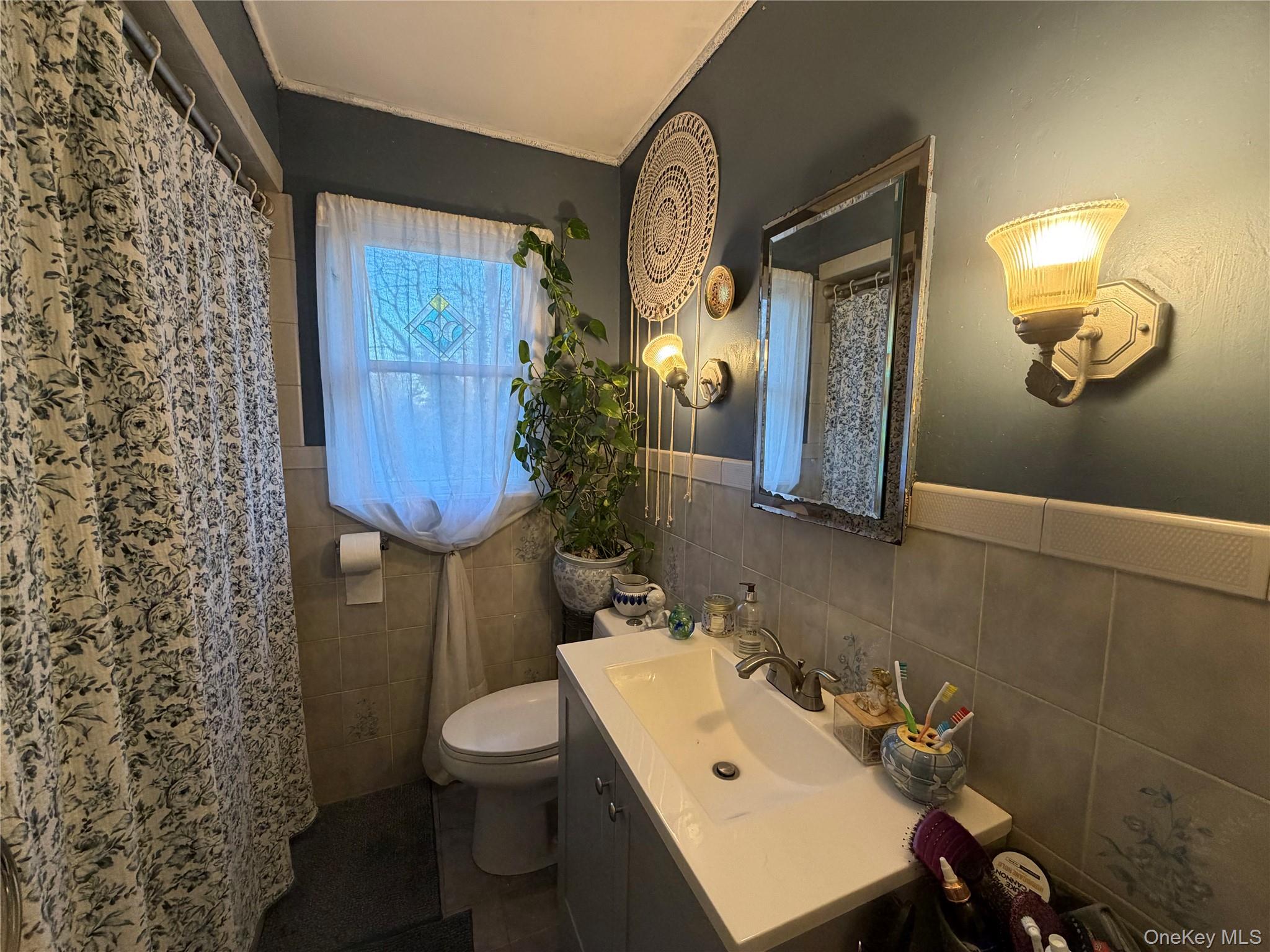 11 Bittermint Street Islip, NY 11751 - Photo 8 of 12 a bathroom with a sink toilet and mirror
