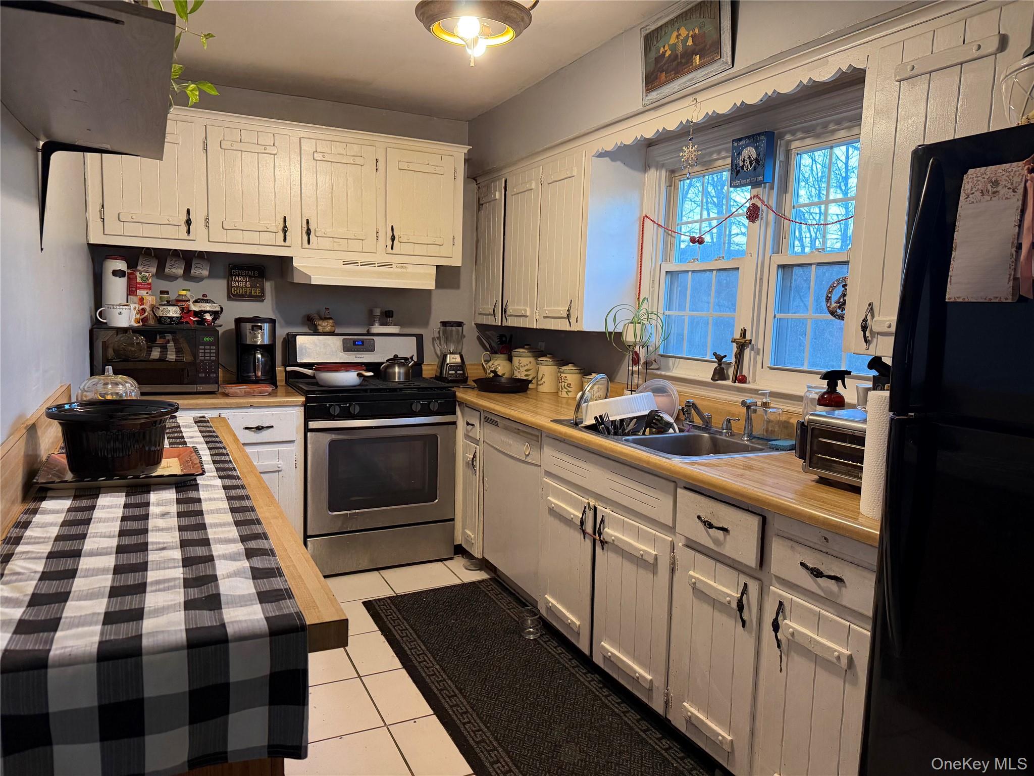 11 Bittermint Street Islip, NY 11751 - Photo 10 of 12 a kitchen with a sink a stove and refrigerator
