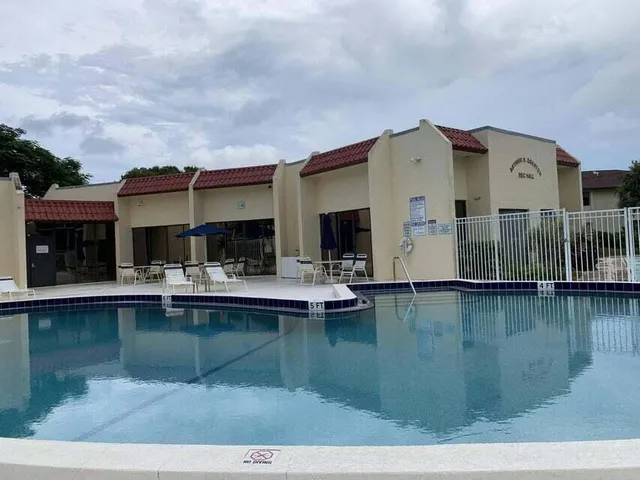 a dining room with furniture a chandelier and a rug