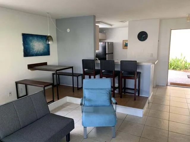 a living room with couches chairs and a flat screen tv