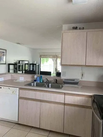 a kitchen with stainless steel appliances granite countertop a sink and a white cabinets