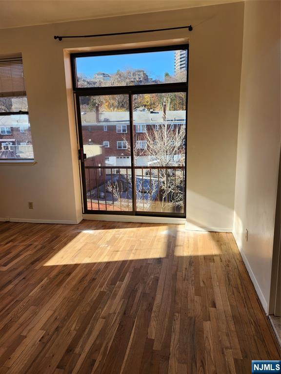840 River Road, Unit 407 Edgewater, NJ 07020 - Photo 13 of 14 a view of empty room with wooden floor and fan