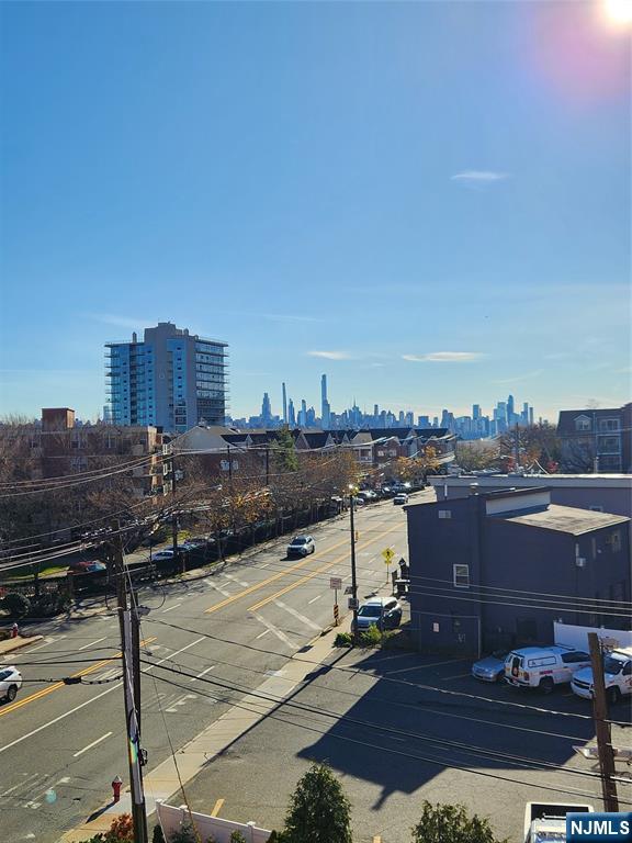 840 River Road, Unit 407 Edgewater, NJ 07020 - Photo 14 of 14 a view of a terrace with wooden floor and city view