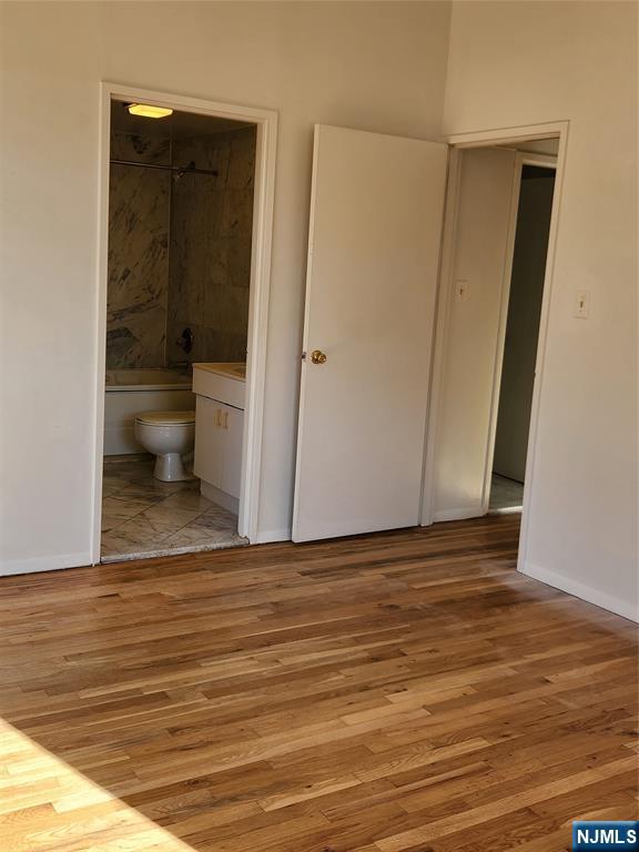 840 River Road, Unit 407 Edgewater, NJ 07020 - Photo 3 of 14 a view of an empty room with wooden floor and a window