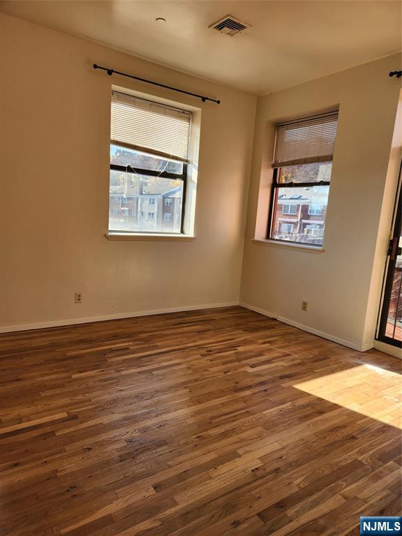 840 River Road, Unit 407 Edgewater, NJ 07020 - Photo 4 of 14 a view of an empty room with wooden floor and a window