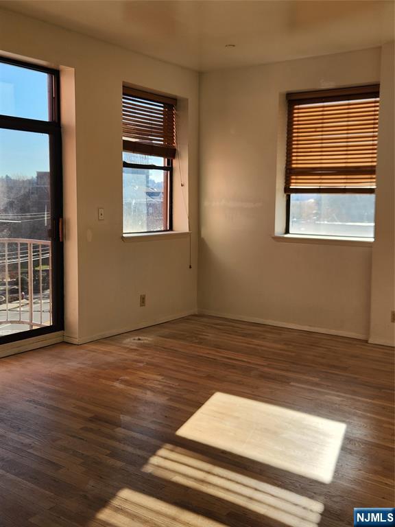 840 River Road, Unit 407 Edgewater, NJ 07020 - Photo 6 of 14 a view of an empty room with wooden floor and a window
