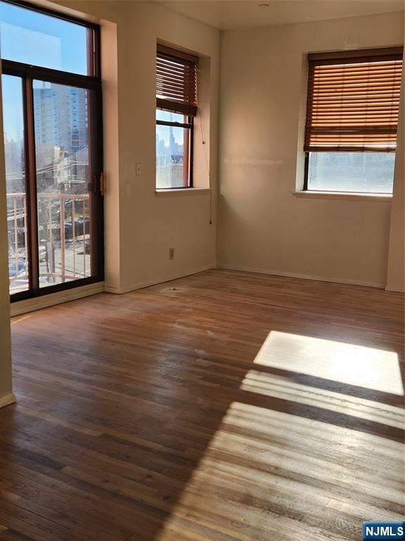 840 River Road, Unit 407 Edgewater, NJ 07020 - Photo 7 of 14 a view of an empty room with wooden floor and a window