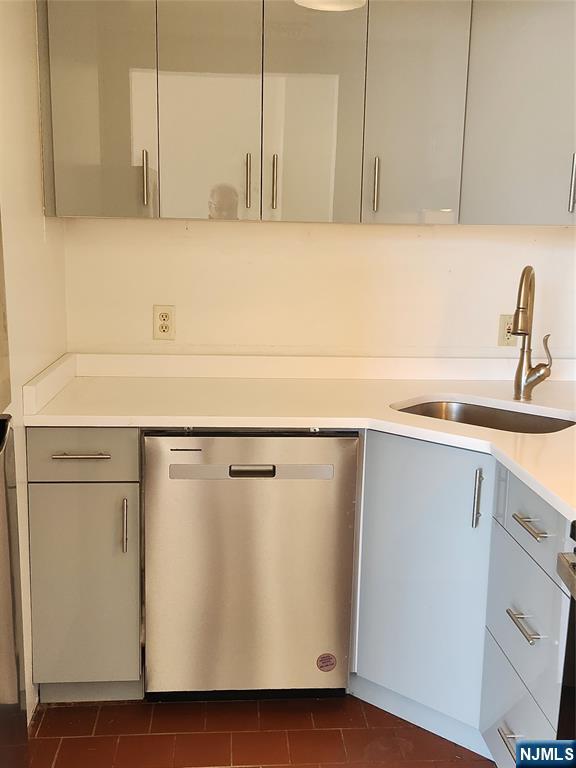 840 River Road, Unit 407 Edgewater, NJ 07020 - Photo 9 of 14 a kitchen with a sink a refrigerator and cabinets