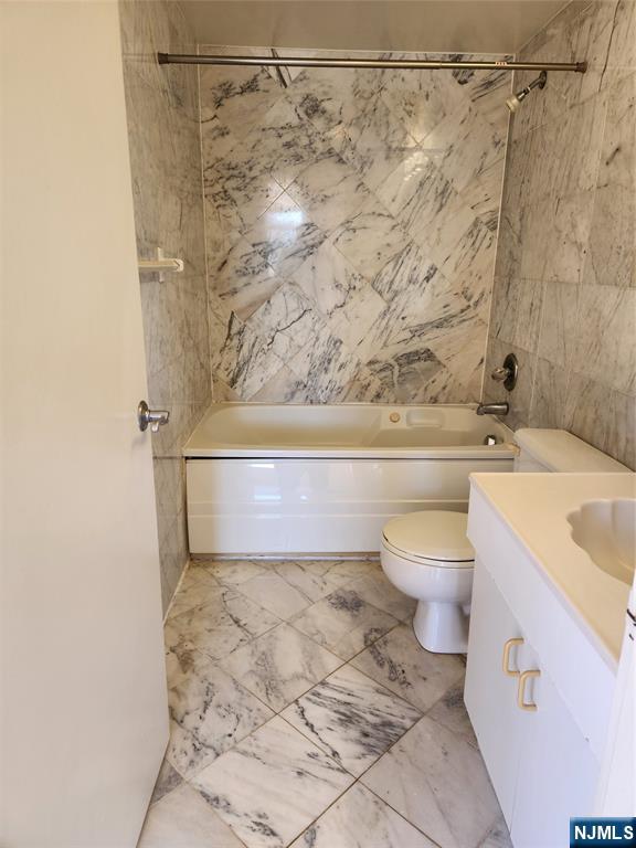 840 River Road, Unit 407 Edgewater, NJ 07020 - Photo 10 of 14 a bathroom with a sink a toilet and shower