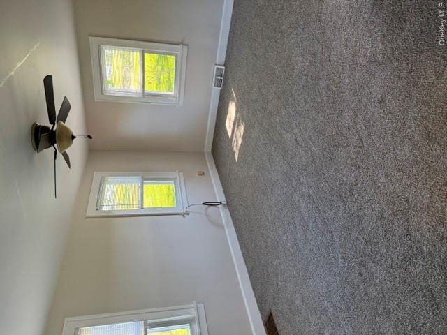 95 Upper Wisner Road Warwick, NY 10990 - Photo 6 of 14 an empty room with windows and chandelier fan