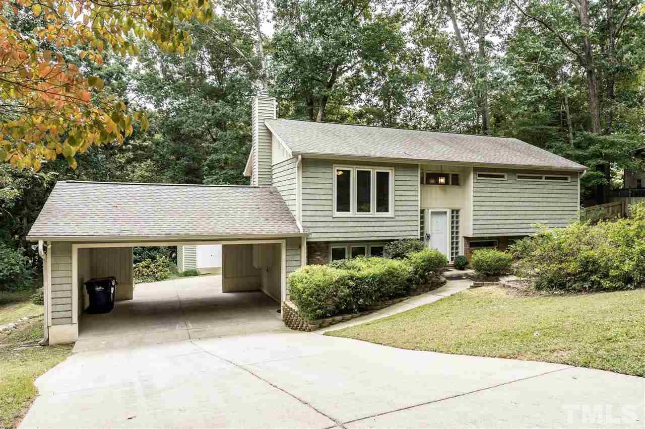 6704 Winding Trail Raleigh, NC 27612 - Photo 1 of 30 a front view of a house with a garden