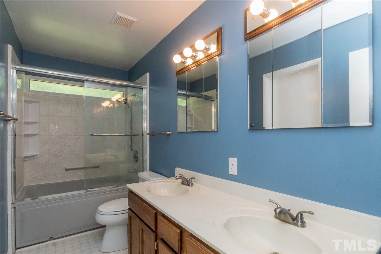 6704 Winding Trail Raleigh, NC 27612 - Photo 14 of 30 a bathroom with a sink toilet and shower