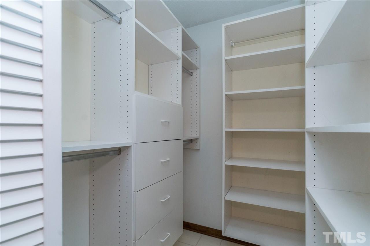 6704 Winding Trail Raleigh, NC 27612 - Photo 17 of 30 a view of walk in closet with empty racks