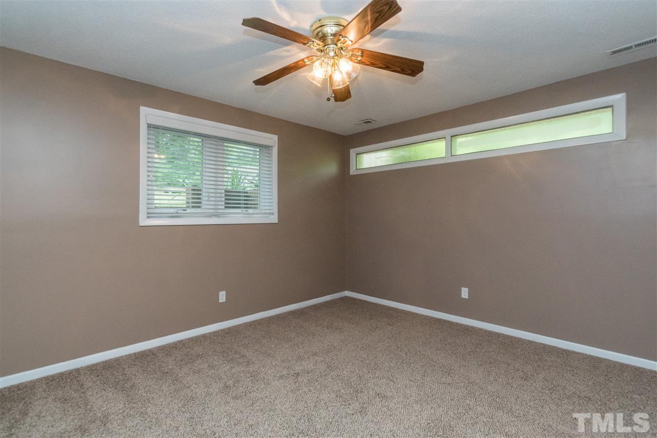 6704 Winding Trail Raleigh, NC 27612 - Photo 19 of 30 an empty room with a window and a fan