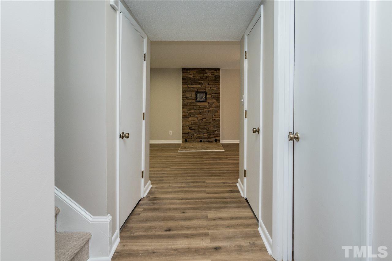 6704 Winding Trail Raleigh, NC 27612 - Photo 20 of 30 a view of a hallway with wooden floor and staircase