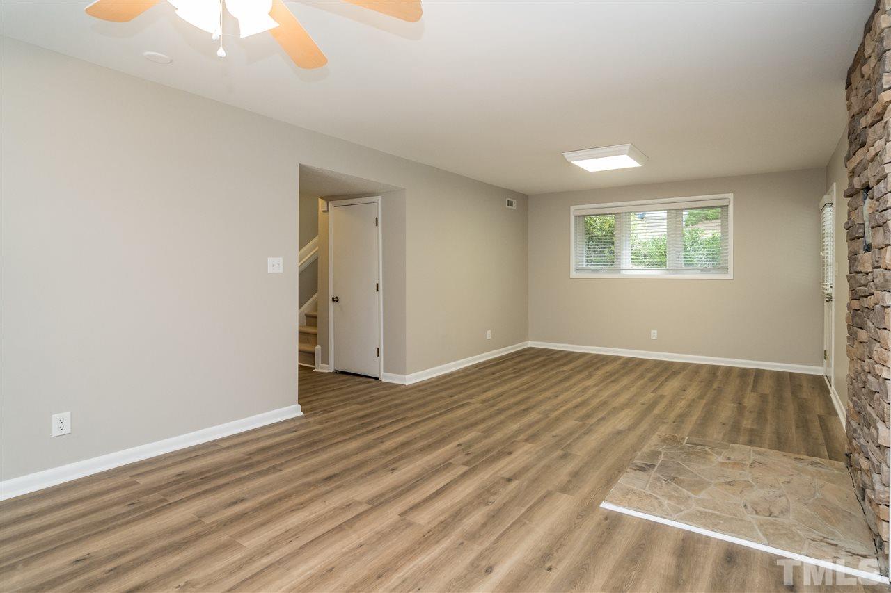 6704 Winding Trail Raleigh, NC 27612 - Photo 23 of 30 an empty room with wooden floor and windows